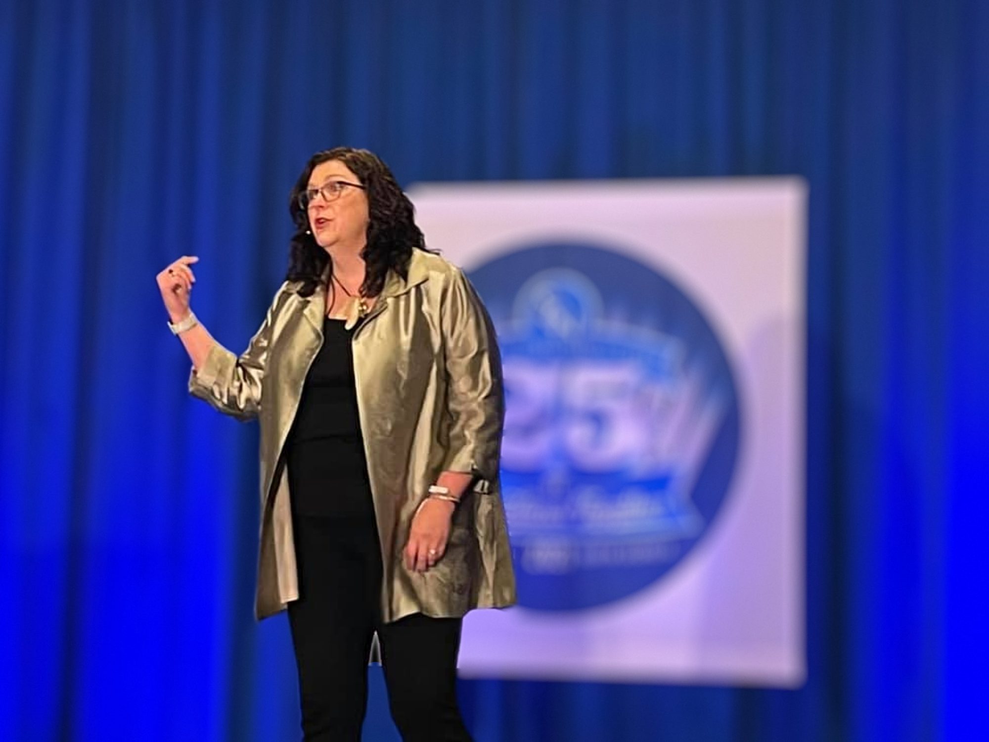 Penny Reed speaking on stage