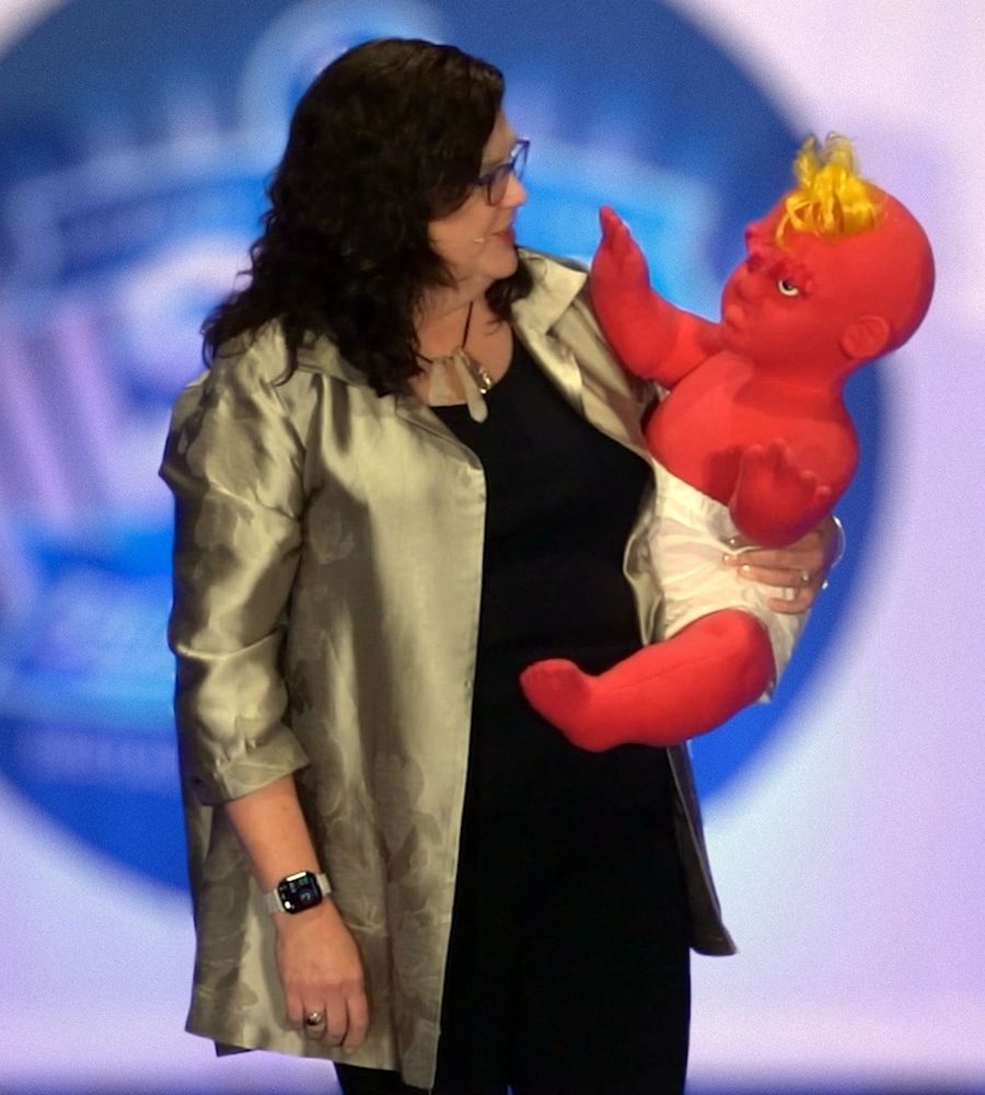 Penny Reed on stage with The Bitter Baby® puppet